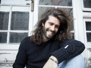 Man with long hair and smiling portrait