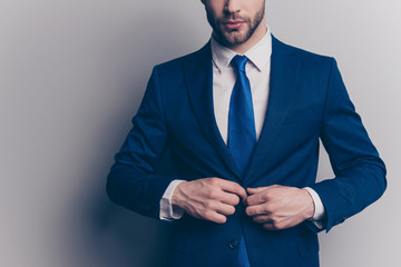 Cropped portrait of stunning, fashionable, cool, virile, rich man with stubble, half face in blue...