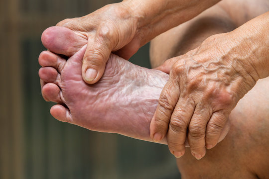 Senior woman's hands massaging her foot, About massage concept
