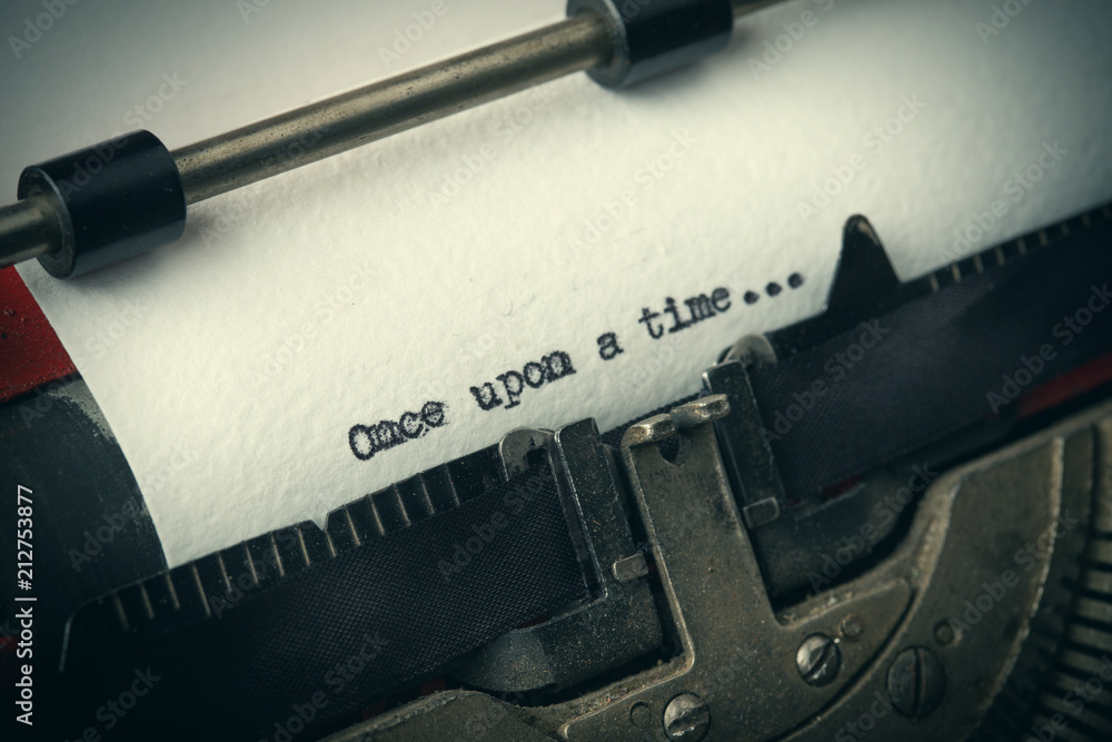 Fototapete close up of old typewriter covered with dust with once upon a time text