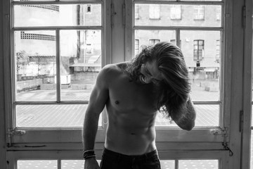 Man with long hair showing his body