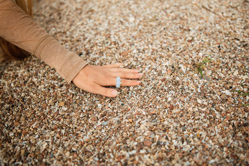 girl holding various mediterranean sea shells in hands closeup
