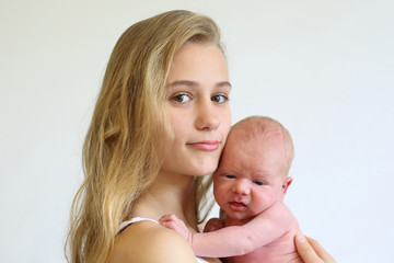 portrait of a teenage girl with a newborn baby