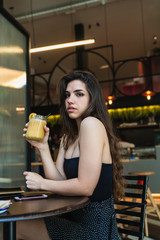 Woman with smoothie looking at camera