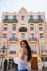 Young lady standing near beautiful building