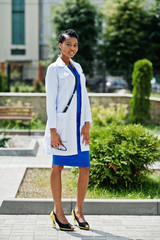 African american doctor female at lab coat with stethoscope outdoor.