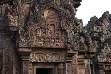 Fototapeta na wymiar Angkor Cambodia, Krishna killing the demon king Kamsa bas relief over the western pediment, southern library at the 10th century Banteay Srei temple