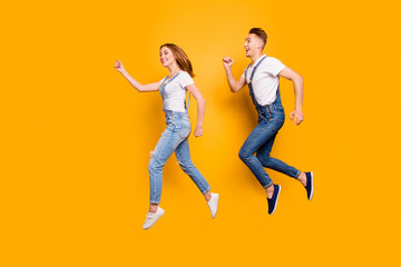 Fototapeta na wymiar Teen age two cheerful joyful people sale discount shopping concept. Profile full length size photo portrait of funky funny rejoicing beautiful spouses hurrying up isolated background copy-space