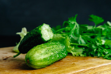 fresh hommade cucumber on the board with salad parsley dill celery