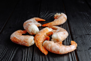 frozen prawns on a dark wooden background shrimp