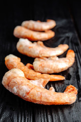 frozen prawns on a dark wooden background shrimp
