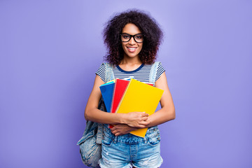 Portrait of smart educated girl with beaming smile in denim outfit eyewear having colorful...
