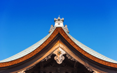 Fototapeta na wymiar View of the carved wooden roof of the building, Kyoto, Japan. Copy space for text. Isolated on blue background.