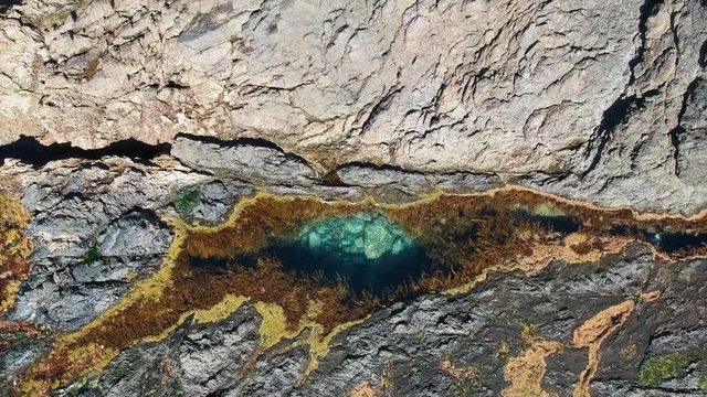 Stunning close up aerial drone view of a rock pool at the Mermaid Rock Pools at Matapouri Bay near Whangarei on the North Island of New Zealand. The rock pools are a popular tourist destination. 