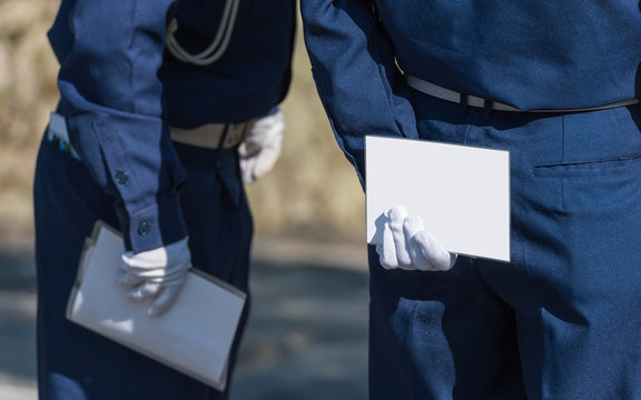 A Man In White Gloves Holds A White Sheet Behind His Back, Kyoto, Japan. Copy Space For Text. Frame For Text.