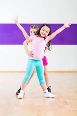 Children dancing modern group choreography in dance class
