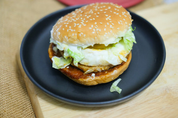Tasty burger with pork and fried egg
