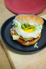 Tasty burger with pork and fried egg