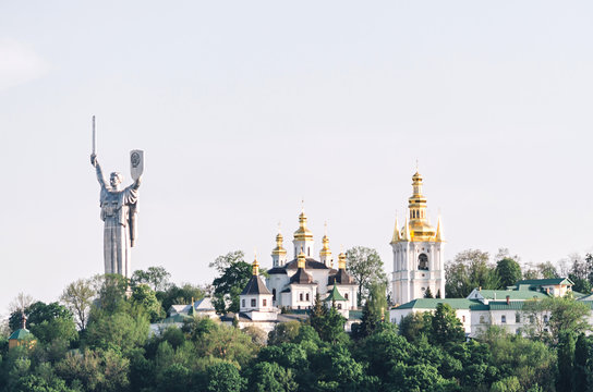 The Motherland Monument and Pechersk Lavra Cathedral, Kiev, Ukraine. View from Dnipro river