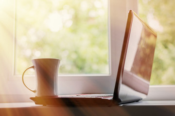 Coffee and laptop. The concept of freelancing, preparation for work, a break. Toned.