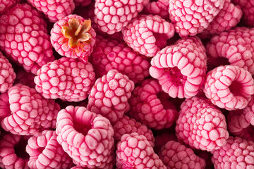 Background of frozen raspberries. Ripe raspberries with frosty freshness.