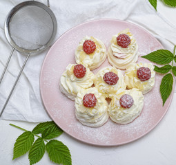 cakes made of egg white and whipped white cream with raspberries
