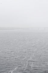 View across the river on a calm day, heavy fog in the air