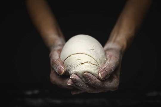 woman's hands kneading bread