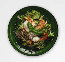 Caesar restaurant salad, isolated on white