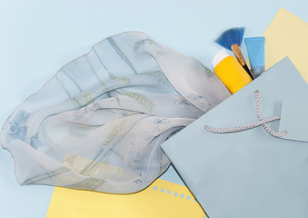 gift bag with a handle, part of a dress on a turquoise background