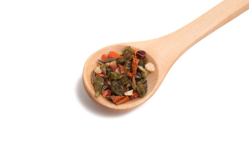 wooden spoon filled with spices isolated on the white