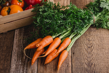 Fresh carrots on rustic table