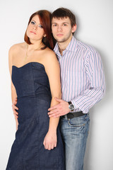 Young couple hugging on white bakcgroind in studio. Fashion, beauty and advertisement concept. Close up. Copy space for text