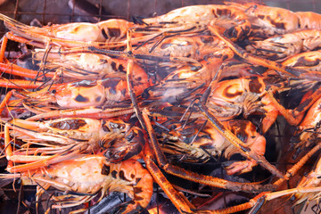 Close up of shrimp grilled on a hot charcoal stove in the party at camping.
