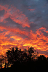 Obraz na płótnie Canvas dramatic flaming sky with orange clouds