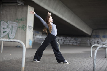 Modern Dancer in Motion on Sidewalk