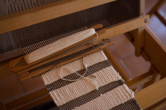 Close up of machine with silk thread in factory