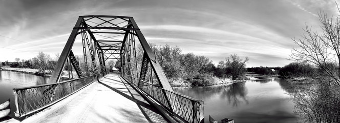 Panorama of an old iron bridge in black and white