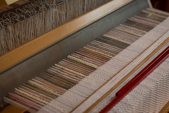 Close up of machine with silk thread in factory
