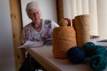 Senior woman reading a magazine in shop