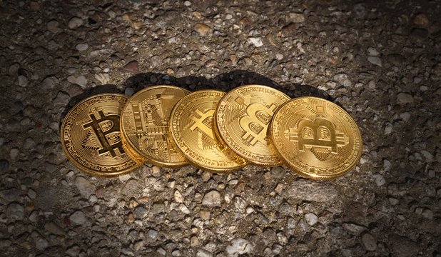 Belgrade, Serbia - June 12, 2018: Golden Bitcoin Coins on ground - Powered by Adobe