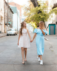 Two girls having a walk on the streets of city.