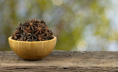 star anise in a bowl on wood table