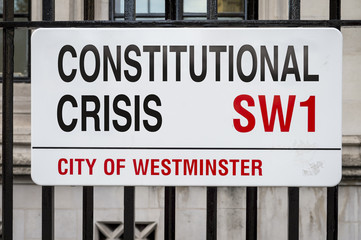 Street Sign altered to read 'Constitutional Crisis' in protest to the Brexit process outside Houses of Parliament in London, UK