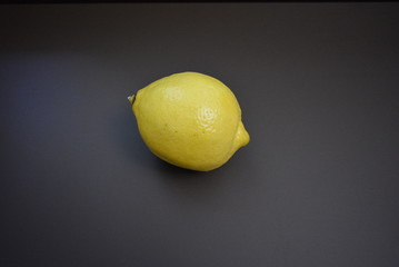 Fresh fruit, yellow lemon on an interesting matte background