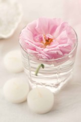 Obraz na płótnie Canvas Spa resort therapy composition. Candles, rose flower, salt, towel. Relax, wellness and mindfulness concept