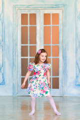Happy smiling and dancing Cute little girl on the studio