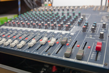 Closeup of the professional audio mixing console. Selective focus.