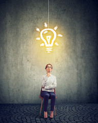 Smart businesswoman with light bulb above head