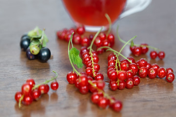 Summer berries.Red and Black Curratnts.Red Juice Glass on Wooden table. Food Concept. 